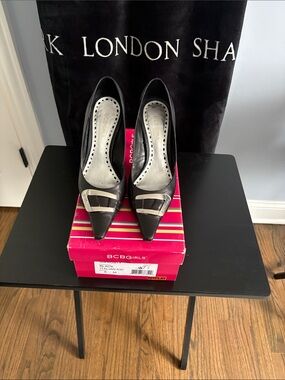 BCBGirls Black Pointed Toe Pumps with Silver Buckle
